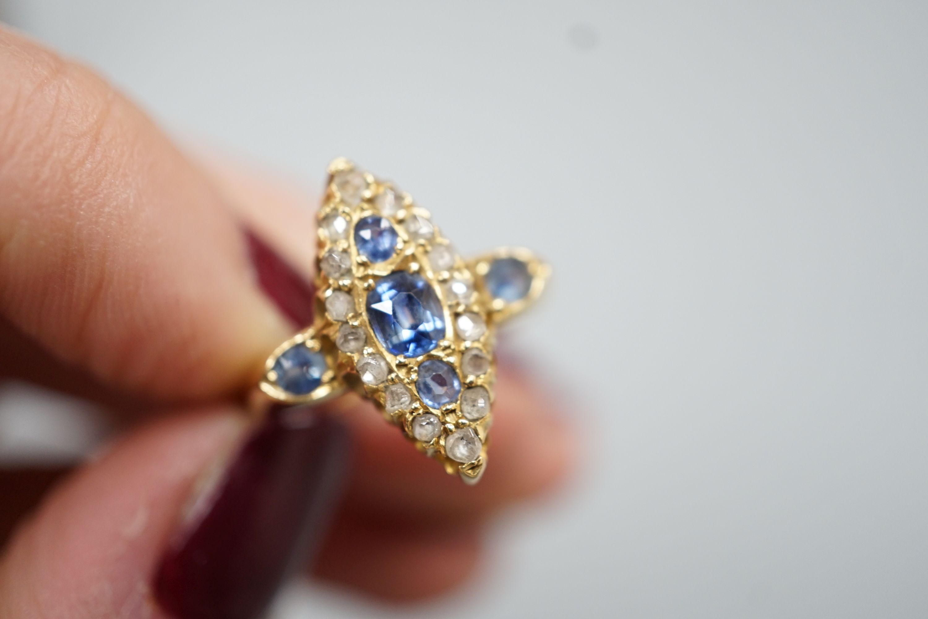 An Edwardian 18ct gold, sapphire and diamond set marquise set cluster ring, size K, gross weight 3.2 grams